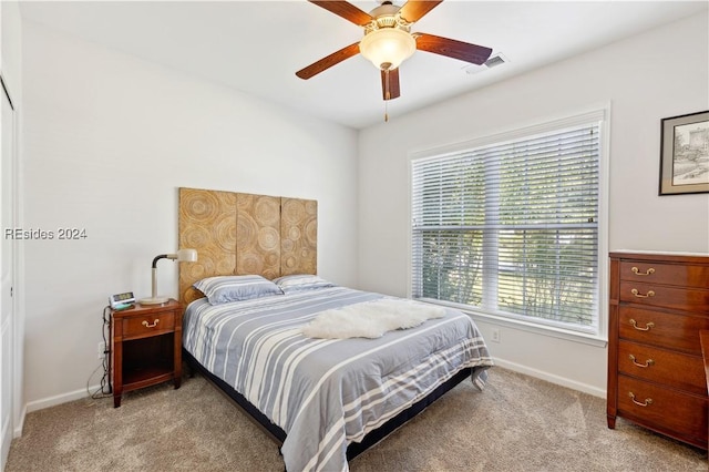 bedroom with light colored carpet and ceiling fan