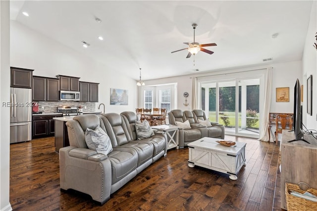 living room featuring sink, dark hardwood / wood-style floors, ceiling fan with notable chandelier, and high vaulted ceiling