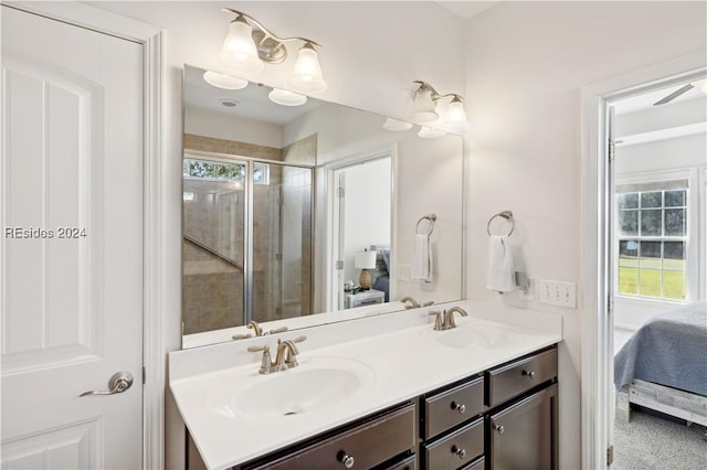 bathroom featuring vanity and a shower with shower door