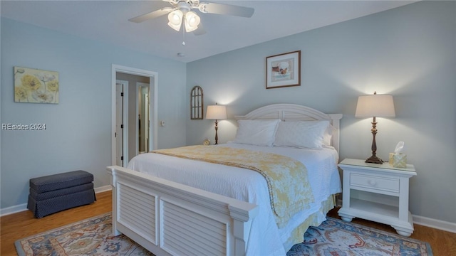 bedroom with hardwood / wood-style flooring and ceiling fan