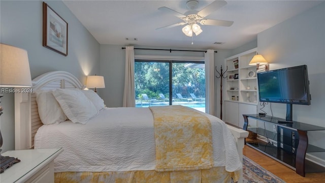 bedroom with hardwood / wood-style flooring, access to outside, and ceiling fan