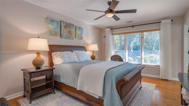 bedroom with ceiling fan and light hardwood / wood-style flooring