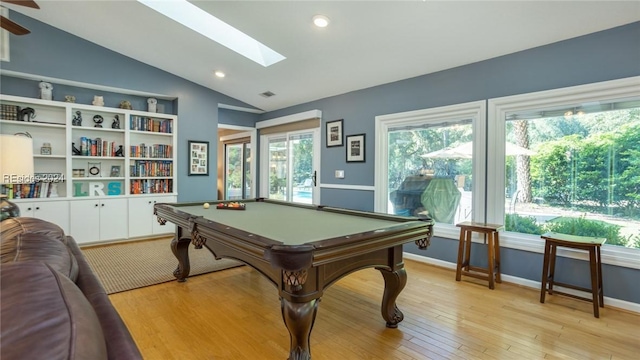 playroom with billiards, vaulted ceiling with skylight, built in features, and light hardwood / wood-style flooring