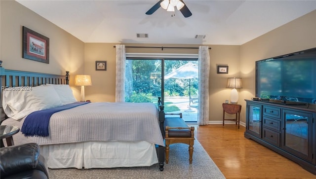 bedroom featuring ceiling fan, access to exterior, and light hardwood / wood-style floors