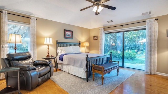 bedroom featuring hardwood / wood-style floors, access to exterior, and ceiling fan