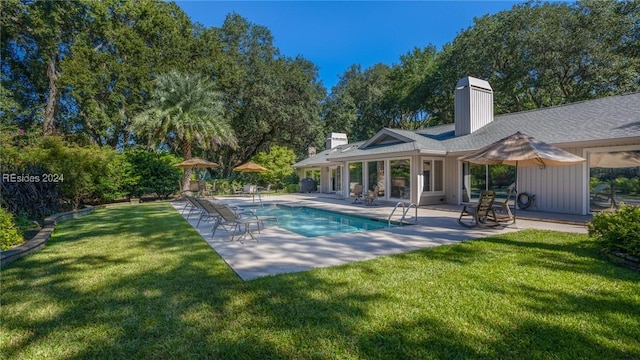 view of pool featuring a yard and a patio area