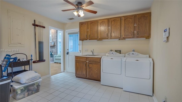 clothes washing area featuring sink, cabinets, light tile patterned floors, ceiling fan, and washer and clothes dryer