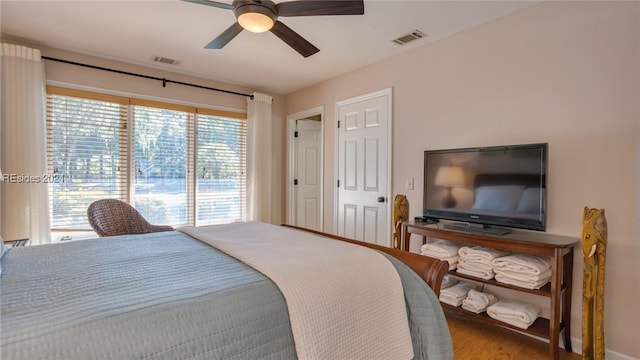 bedroom featuring ceiling fan, wood-type flooring, and access to outside