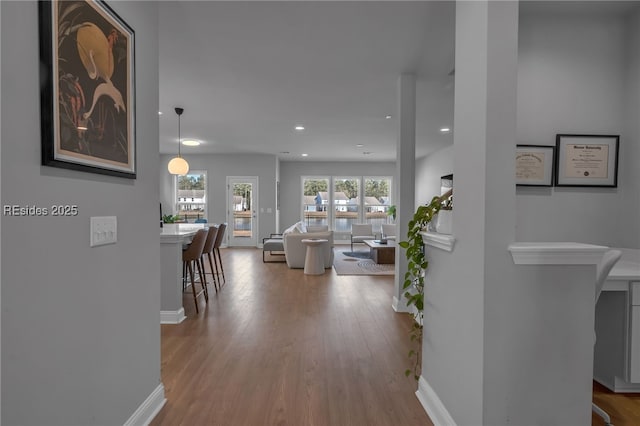 hallway with hardwood / wood-style floors