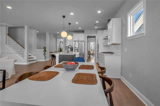 dining space featuring sink and light wood-type flooring