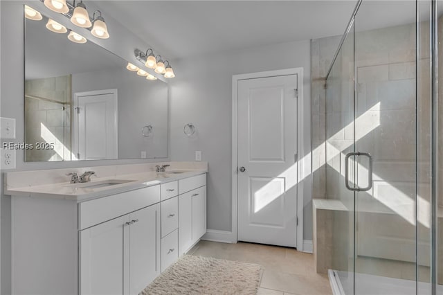 bathroom with vanity, a shower with shower door, and tile patterned floors