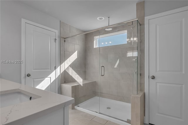 bathroom featuring walk in shower, tile patterned floors, and vanity