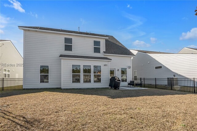 back of property with a yard and a patio area