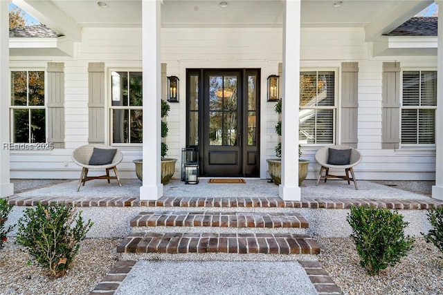 view of exterior entry with a porch