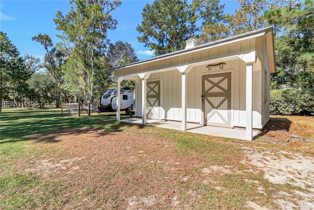 view of outbuilding featuring a yard