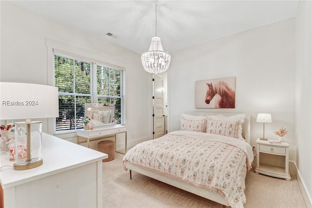 bedroom featuring a notable chandelier and light colored carpet