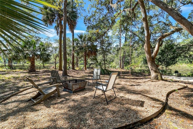 view of yard with an outdoor fire pit