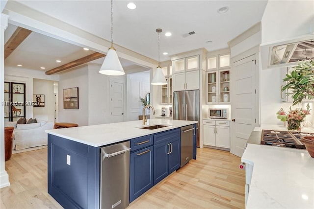 kitchen with pendant lighting, sink, white cabinetry, stainless steel appliances, and beamed ceiling