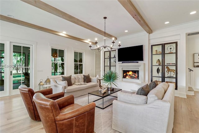 living room with french doors, beam ceiling, and light hardwood / wood-style floors