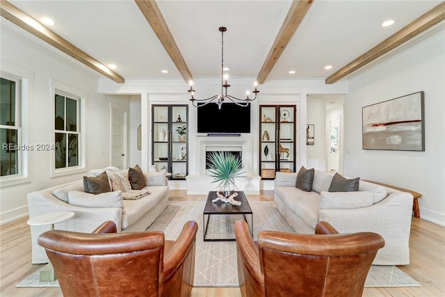 living room featuring beam ceiling, built in features, and light wood-type flooring