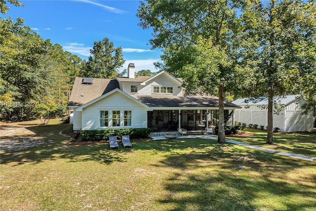 rear view of house featuring a yard