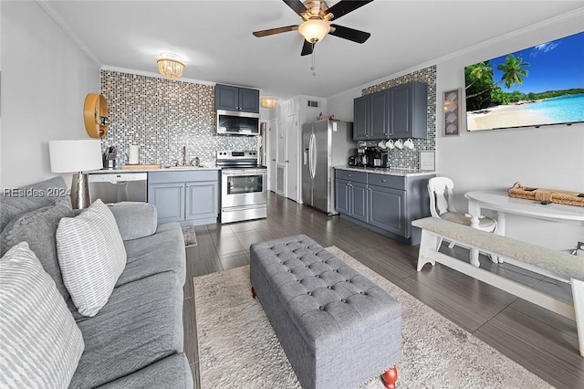 living room with ornamental molding, dark wood-type flooring, wet bar, and ceiling fan