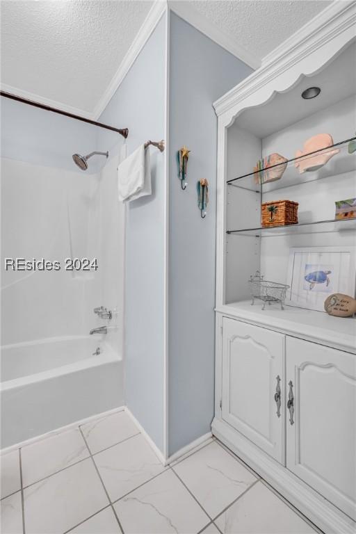 bathroom with bathing tub / shower combination, crown molding, and a textured ceiling