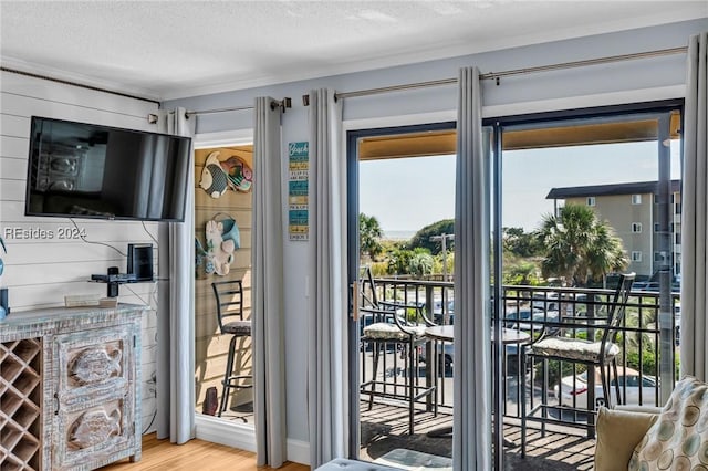 doorway to outside with hardwood / wood-style floors and a textured ceiling