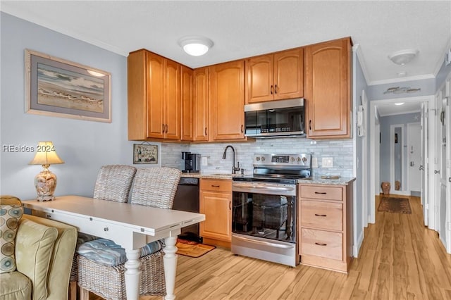 kitchen with appliances with stainless steel finishes, sink, backsplash, ornamental molding, and light stone countertops