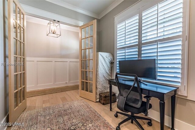 home office with french doors, crown molding, and light hardwood / wood-style flooring