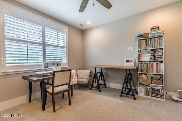 carpeted home office with plenty of natural light and ceiling fan