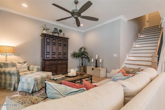 living room featuring crown molding, ceiling fan, and light hardwood / wood-style floors