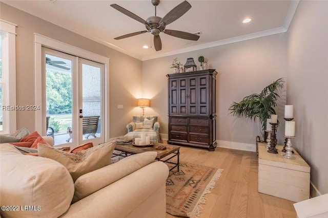 living room featuring ornamental molding, ceiling fan, light wood-type flooring, and french doors