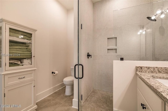 bathroom with tile patterned floors, vanity, toilet, and an enclosed shower