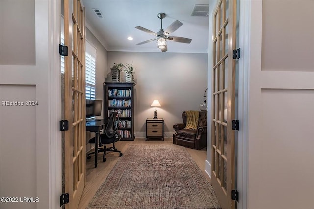 office space with ornamental molding, ceiling fan, light hardwood / wood-style floors, and french doors