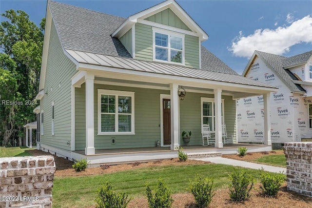 view of front of house featuring a porch and a front yard