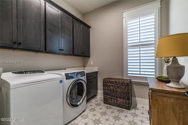 laundry area featuring separate washer and dryer and cabinets