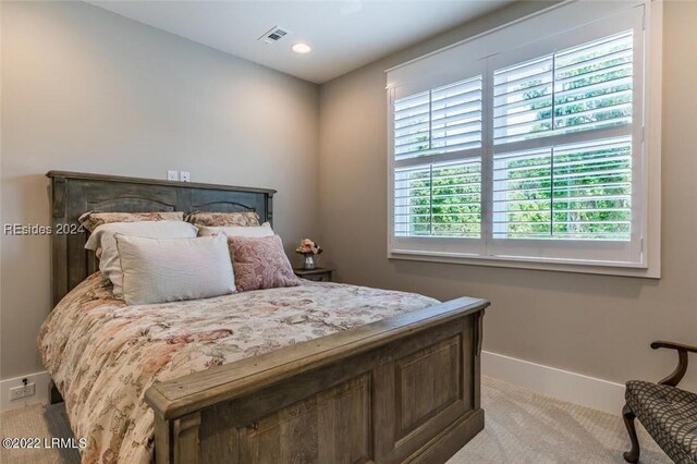 bedroom with light colored carpet