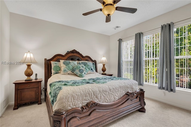 bedroom with light carpet and ceiling fan