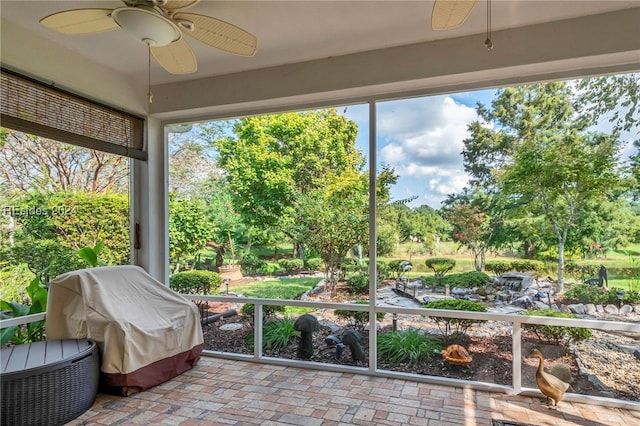 sunroom / solarium featuring ceiling fan