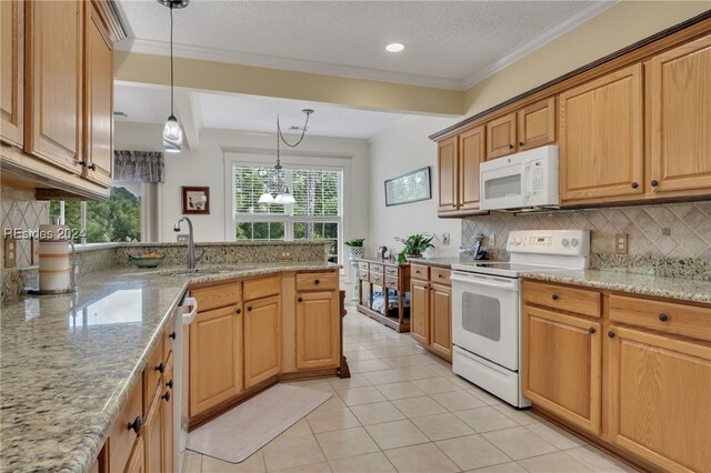 kitchen featuring white appliances, decorative light fixtures, light stone countertops, and backsplash