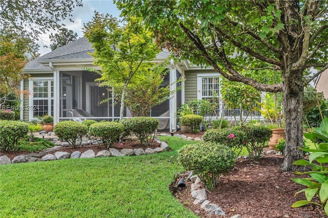 exterior space with a front yard and a sunroom