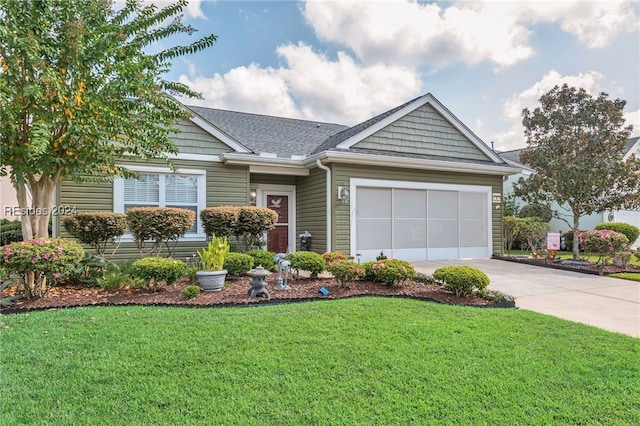 view of front of home with a garage and a front lawn