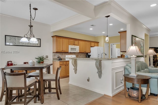 kitchen with pendant lighting, light stone counters, beamed ceiling, white appliances, and backsplash