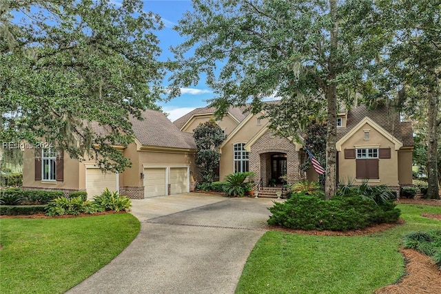 view of front of home with a garage and a front yard