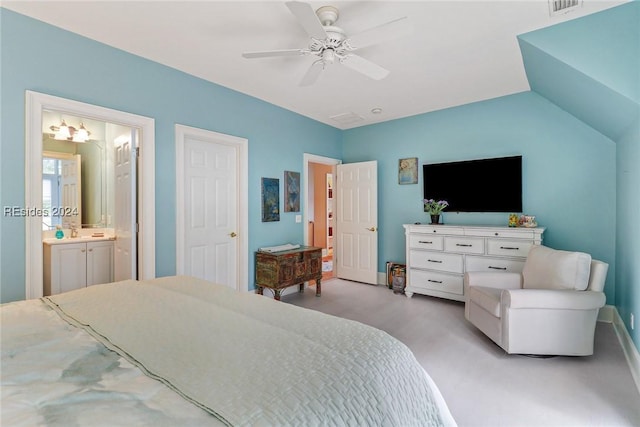 bedroom featuring ensuite bath, vaulted ceiling, and ceiling fan