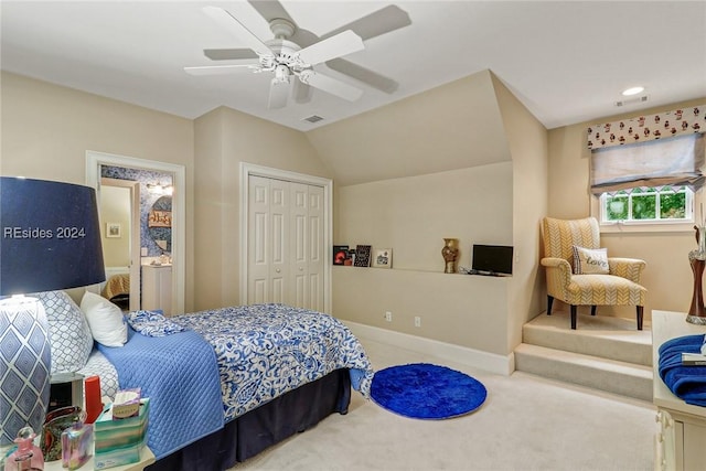 bedroom with vaulted ceiling, carpet flooring, ceiling fan, and a closet