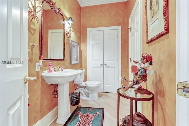 bathroom with ornamental molding, toilet, and wood-type flooring