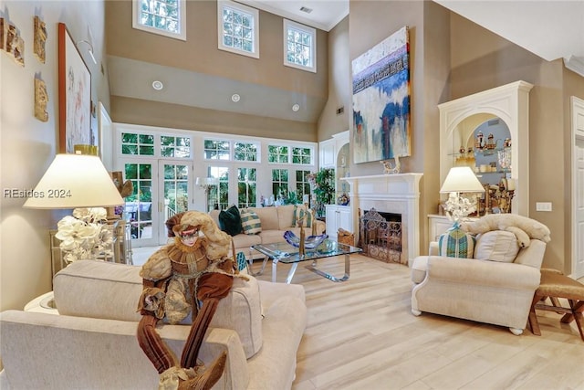 living room featuring hardwood / wood-style floors and a towering ceiling