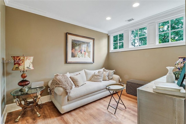 living room featuring light hardwood / wood-style flooring and ornamental molding